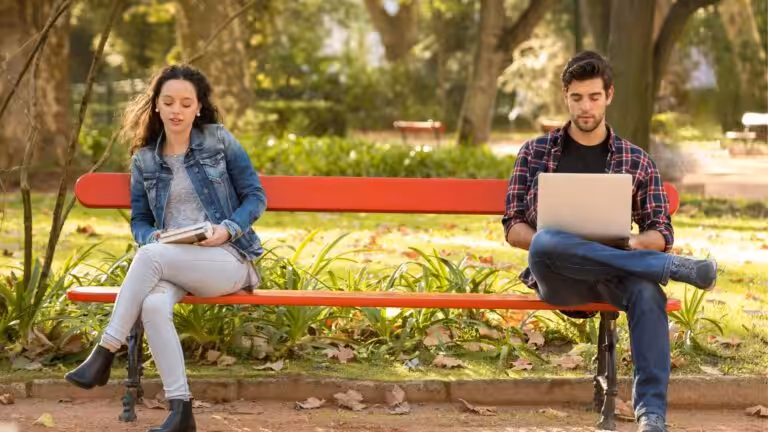 Person wanting to join a group conversation but hesitating, showing social reluctance